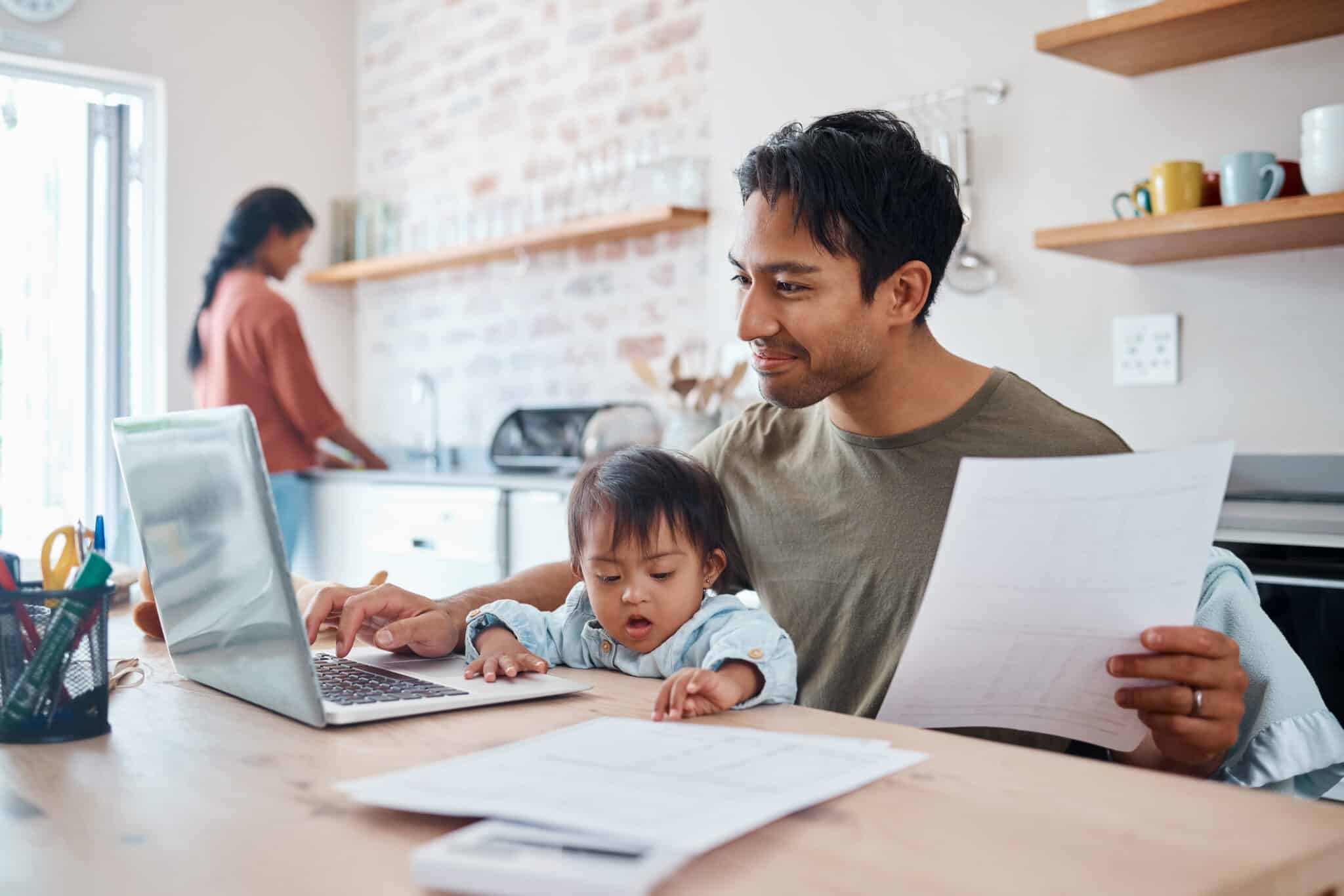 A Nashville resident opens a checking account online from home on a laptop, showing the convenience of digital banking.