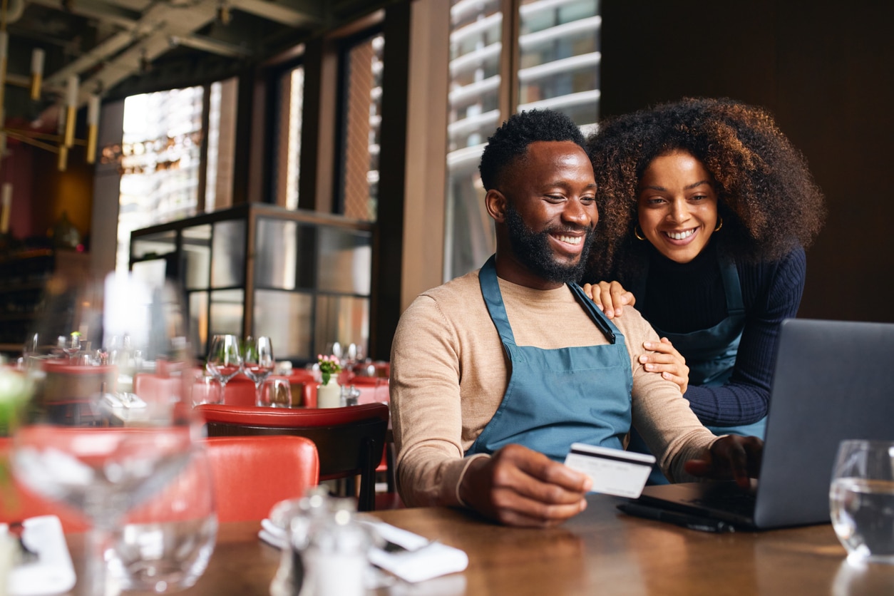 Owners of a business opening up an online business banking account.